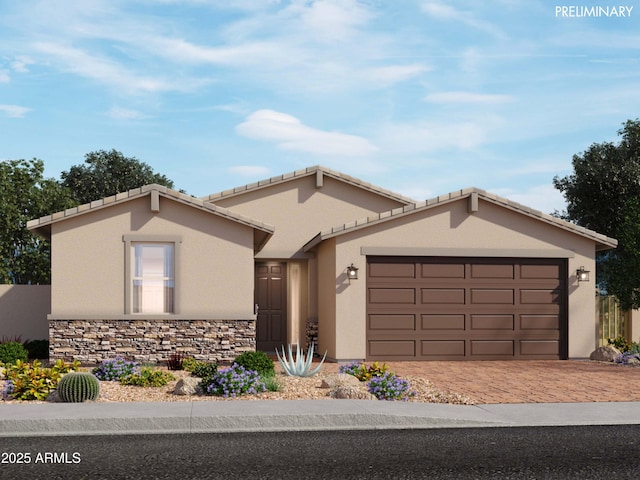 single story home featuring a garage, stone siding, decorative driveway, and stucco siding