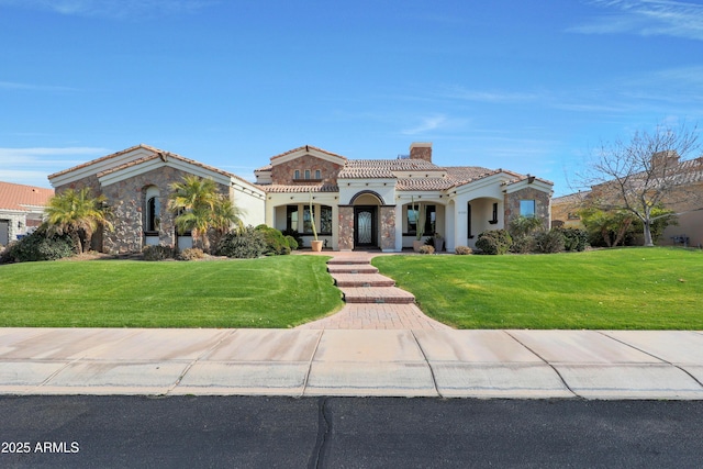 mediterranean / spanish-style house with a front yard