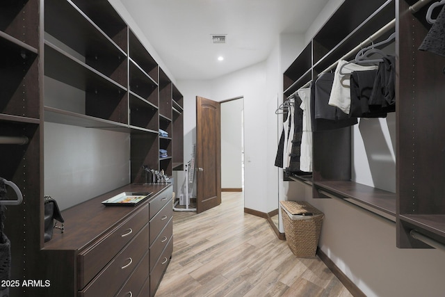 walk in closet featuring light hardwood / wood-style flooring