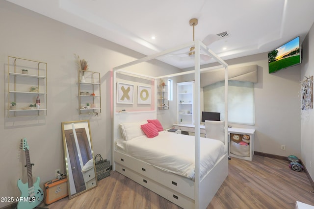 bedroom with hardwood / wood-style flooring