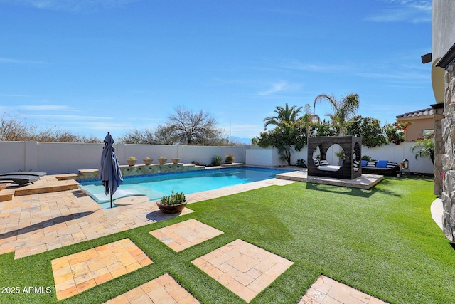 view of swimming pool with a patio area and a lawn