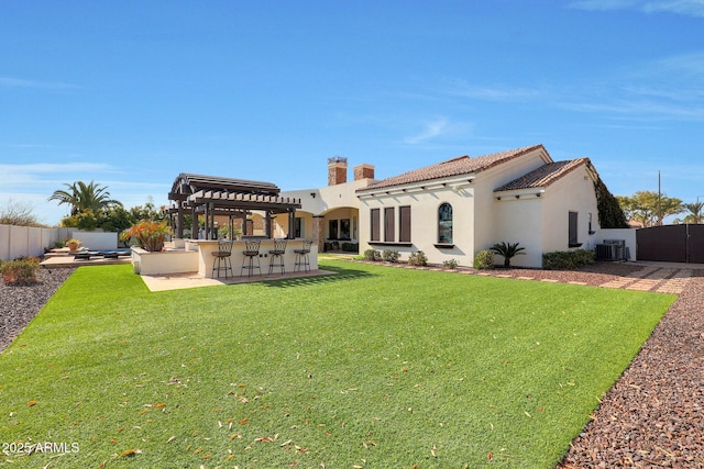 rear view of property with central AC, a patio area, a lawn, a pergola, and an outdoor bar