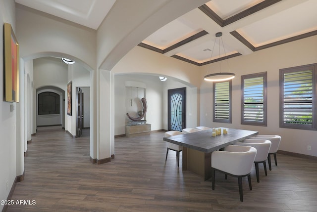 dining room with dark hardwood / wood-style floors, coffered ceiling, and beam ceiling