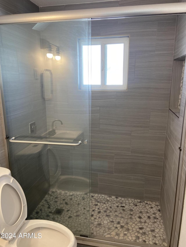 full bath with a shower stall and toilet