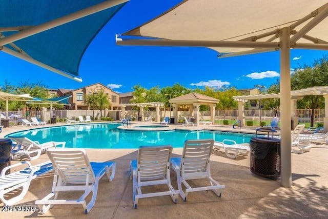 view of pool with a hot tub, a patio area, and a gazebo