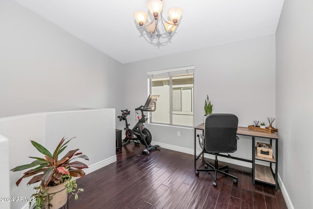 home office featuring dark hardwood / wood-style flooring and a notable chandelier