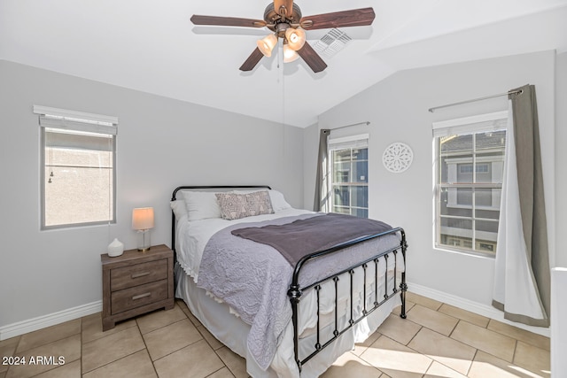 tiled bedroom with lofted ceiling and ceiling fan