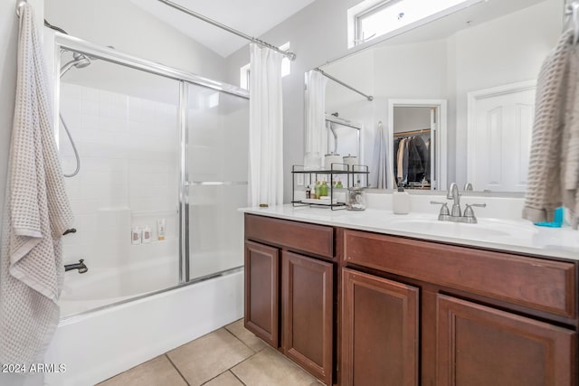 bathroom featuring tub / shower combination, vanity, lofted ceiling, and tile patterned flooring