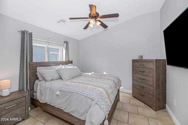 tiled bedroom with ceiling fan and vaulted ceiling