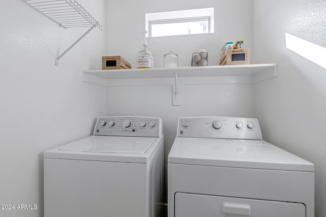 laundry room featuring washing machine and clothes dryer