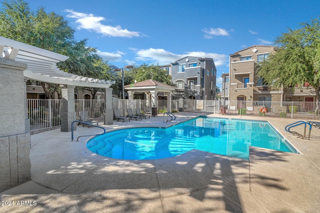 view of swimming pool featuring a pergola and a patio