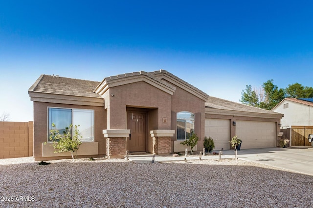 single story home with stucco siding, an attached garage, concrete driveway, and fence