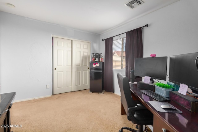 office area featuring visible vents, baseboards, and carpet