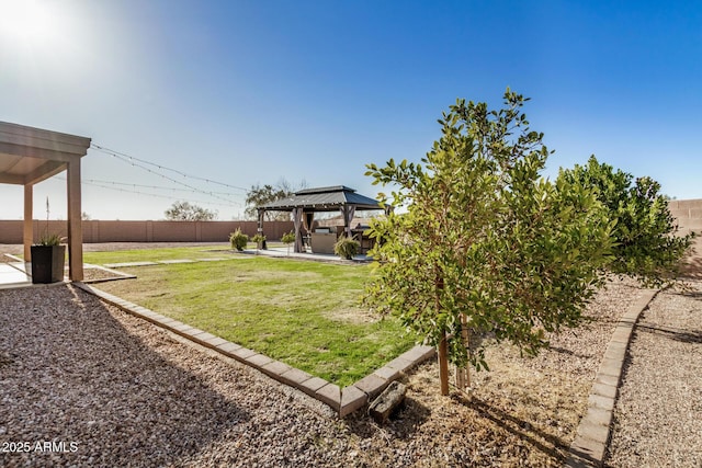 view of yard featuring a gazebo, fence private yard, and a patio area