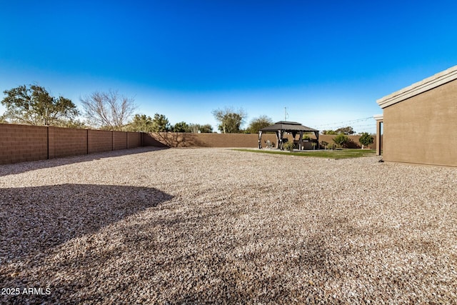 view of yard featuring a gazebo and a fenced backyard