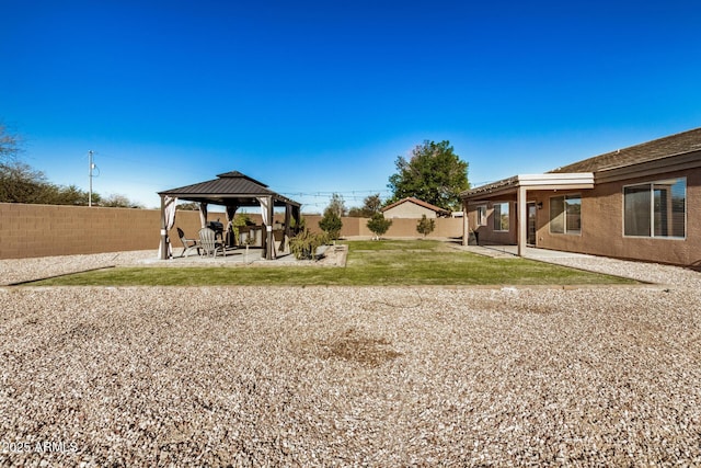 view of yard featuring a gazebo, a fenced backyard, and a patio