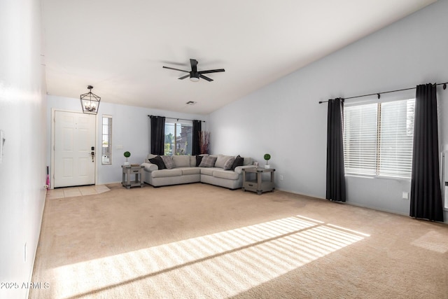 unfurnished living room featuring ceiling fan, lofted ceiling, and carpet