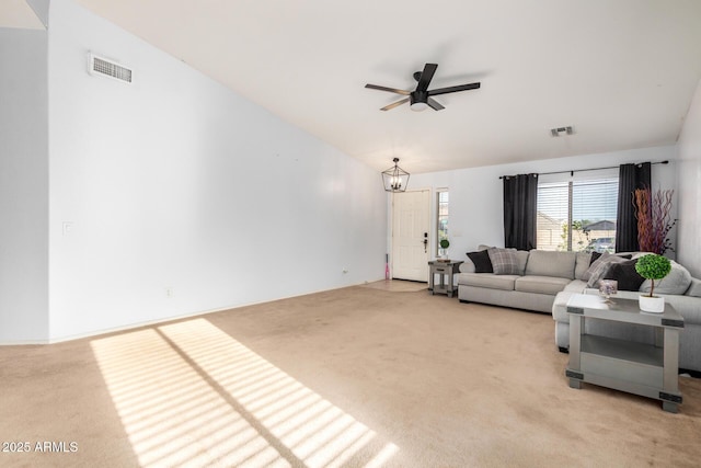 living area featuring visible vents, light carpet, and a ceiling fan