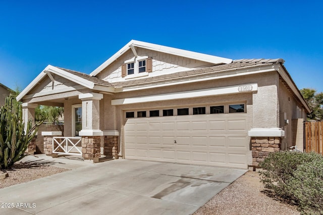 1501 S 122nd Ave, Avondale, AZ 85323 - view of front of home with stone siding, concrete driveway, a garage, covered porch, and stucco siding