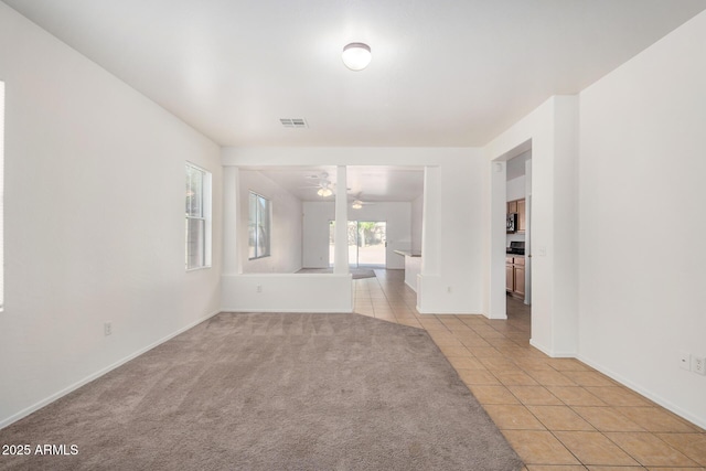 1501 S 122nd Ave, Avondale, AZ 85323 - spare room featuring light tile patterned flooring, ceiling fan, and light carpet