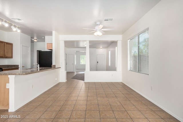 1501 S 122nd Ave, Avondale, AZ 85323 - kitchen with refrigerator, ceiling fan, healthy amount of natural light, and light tile patterned floors