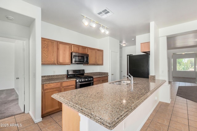 1501 S 122nd Ave, Avondale, AZ 85323 - kitchen with stainless steel appliances, light tile patterned floors, a peninsula, and brown cabinetry