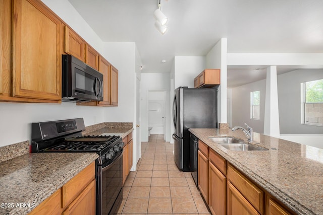 1501 S 122nd Ave, Avondale, AZ 85323 - kitchen with gas range oven, light stone counters, light tile patterned floors, and dishwasher