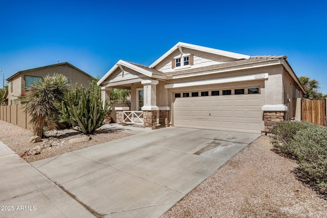 1501 S 122nd Ave, Avondale, AZ 85323 - view of front of home with stone siding, a garage, driveway, covered porch, and stucco siding