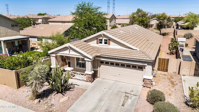 1501 S 122nd Ave, Avondale, AZ 85323 - view of front of property featuring driveway, an attached garage, stone siding, and a residential view