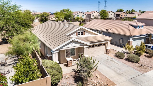 1501 S 122nd Ave, Avondale, AZ 85323 - view of front facade featuring stone siding, driveway, stucco siding, a residential view, and a garage