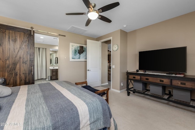 carpeted bedroom featuring ceiling fan and ensuite bath