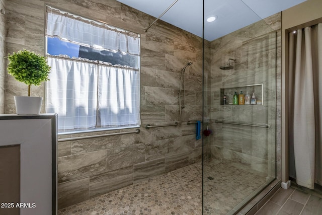 bathroom with a tile shower