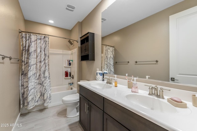 full bathroom featuring shower / tub combo, vanity, and toilet