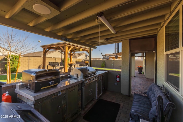 view of patio with grilling area and an outdoor kitchen