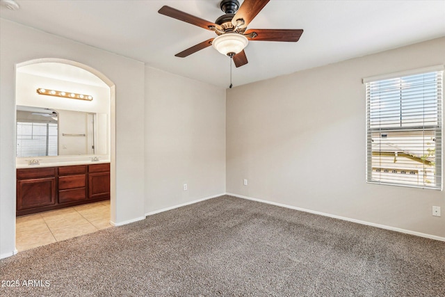 4380 E Renee Dr, Phoenix, AZ 85050 - unfurnished bedroom with light carpet, multiple windows, connected bathroom, and baseboards