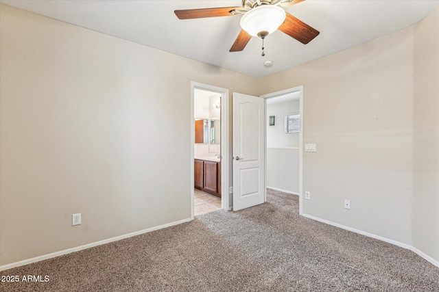 4380 E Renee Dr, Phoenix, AZ 85050 - unfurnished bedroom with light colored carpet, baseboards, ensuite bathroom, and a ceiling fan