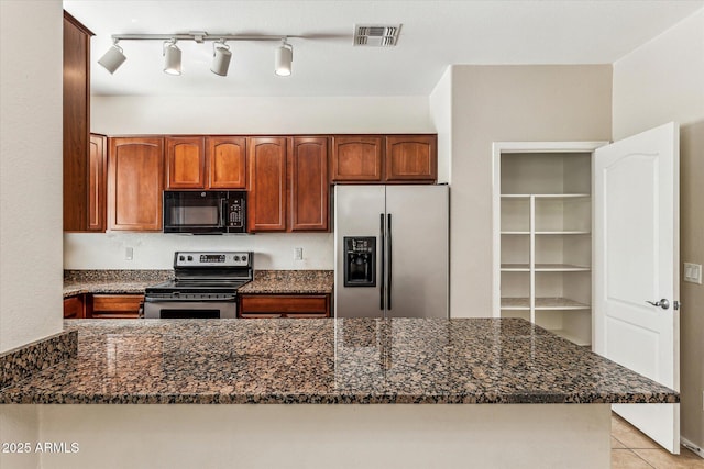4380 E Renee Dr, Phoenix, AZ 85050 - kitchen with stainless steel appliances, dark stone countertops, light tile patterned floors, and a peninsula