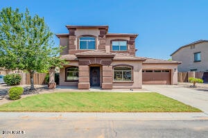 view of front facade with a front yard and a garage