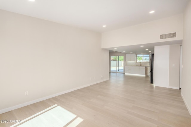 1906 N Evergreen St, Chandler, AZ 85225 - empty room with light wood-type flooring, recessed lighting, baseboards, and a sink