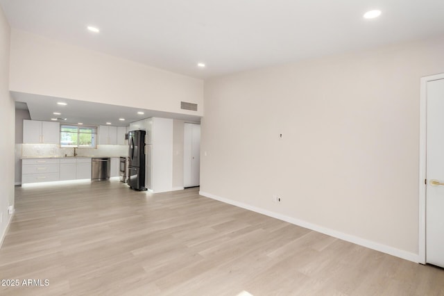 1906 N Evergreen St, Chandler, AZ 85225 - unfurnished living room with a sink, light wood-style floors, recessed lighting, and baseboards