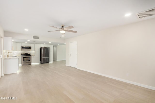 1906 N Evergreen St, Chandler, AZ 85225 - unfurnished living room with ceiling fan, light wood finished floors, baseboards, recessed lighting, and a sink