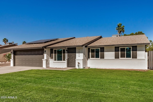 1906 N Evergreen St, Chandler, AZ 85225 - single story home with brick siding, solar panels, a garage, and concrete driveway