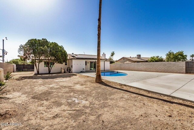 1906 N Evergreen St, Chandler, AZ 85225 - back of property with roof mounted solar panels, a fenced backyard, and a patio