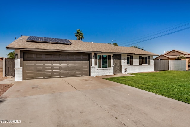 1906 N Evergreen St, Chandler, AZ 85225 - ranch-style house with solar panels, an attached garage, driveway, and brick siding