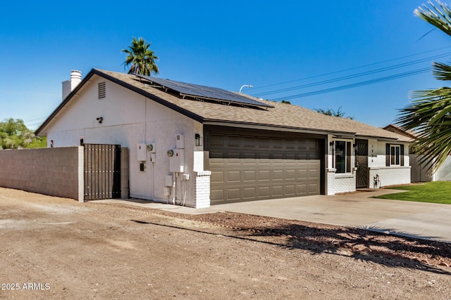 1906 N Evergreen St, Chandler, AZ 85225 - single story home with brick siding, roof mounted solar panels, a garage, and a chimney