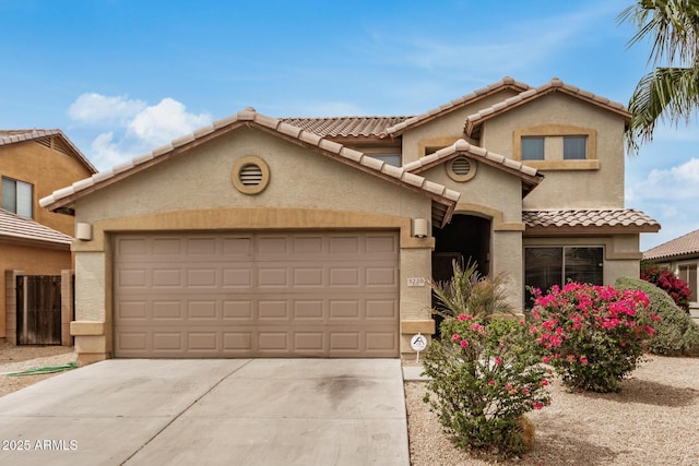 5220 W Desert Ln, Laveen, AZ 85339 - view of front of home with an attached garage, a tiled roof, concrete driveway, and stucco siding