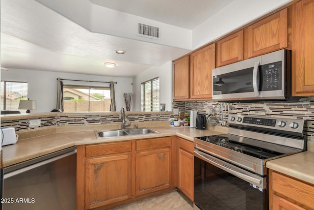 5220 W Desert Ln, Laveen, AZ 85339 - kitchen with appliances with stainless steel finishes, a sink, decorative backsplash, and light countertops