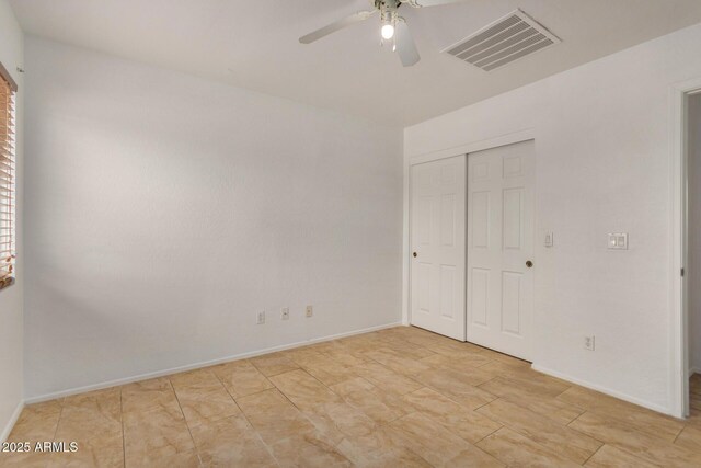 5220 W Desert Ln, Laveen, AZ 85339 - unfurnished bedroom with a closet, baseboards, and ceiling fan