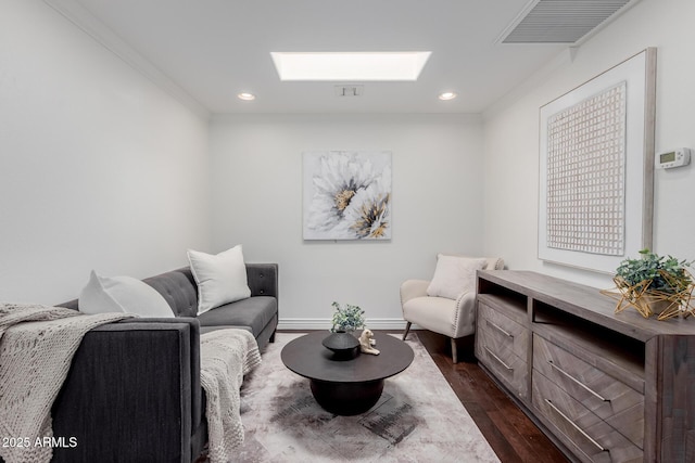sitting room featuring visible vents, a skylight, crown molding, dark wood finished floors, and recessed lighting