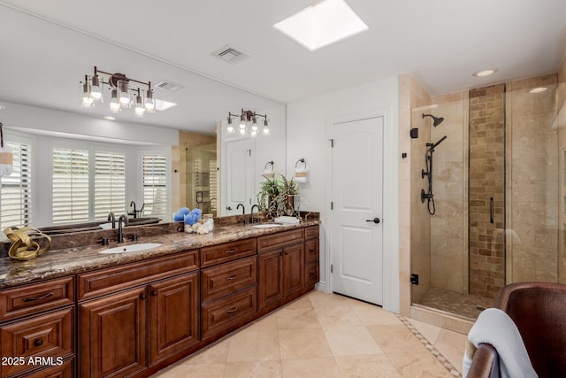 bathroom featuring double vanity, visible vents, a sink, and a stall shower